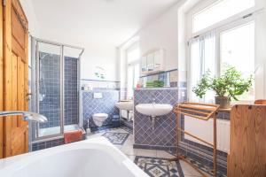 a bathroom with a tub and a sink and a toilet at Körnermühle in Dippoldiswalde +23 photos