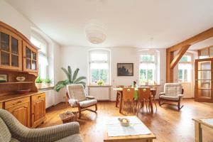 a living room with a table and chairs at Körnermühle in Dippoldiswalde