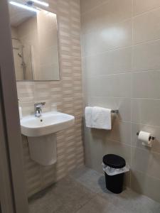 a bathroom with a sink and a mirror at Pension La Puntica in Lo Pagán