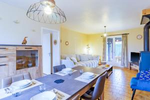a living room with a table and a couch at La Maison de Reta - House avec piscine privée in Rouffignac Saint-Cernin