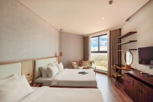 Postel nebo postele na pokoji v ubytování Apec Mandala Beach Mui Ne Resort