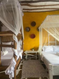 Ένα ή περισσότερα κρεβάτια σε δωμάτιο στο Nyumba ya Mumbi