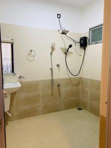a bathroom with a shower and a sink at Abi Restaurant & Villa in Tangalle +5 photos