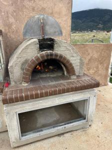 a brick oven with a fire inside of it at Arachova Villa Paris in Kalívia