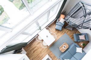 an overhead view of a living room with blue furniture at Biz Apartment Hammarby Sjöstad in Stockholm