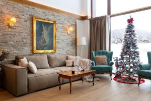 a living room with a christmas tree and a couch at Villa Sofayla near the Pirin Golf Resort in Bansko