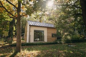 a small house with a solar roof in a yard at Tiny Vacation in Písek