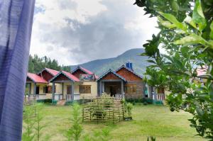 a row of houses with mountains in the background at Nt Riverside Homestay in Dirang Dzong
