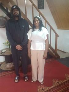 a man and a woman standing on a red carpet at Barrow family cabana in Nuwara Eliya
