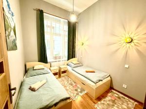a small room with two beds and a window at Oasis Valley in Karlovy Vary