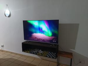 a flat screen tv sitting on a wall at Queens Gardens in Margate