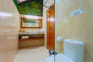 a bathroom with a toilet and a sink at Bintan Exotica Resort By WH - Free Breakfast in Berakit