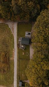 an aerial view of a house in a field with a road at Okno na Beskidy-domek LAS z balią , sauną i niesamowitym widokiem na góry in Maków Podhalański