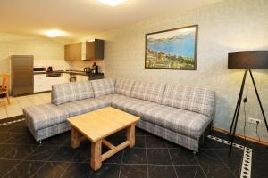 a living room with a couch and a table at Ferienwohnung Quartier18-09 strandnah in Karlshagen +7 photos