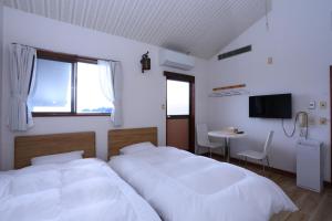 Ένα ή περισσότερα κρεβάτια σε δωμάτιο στο 旅館紀の国