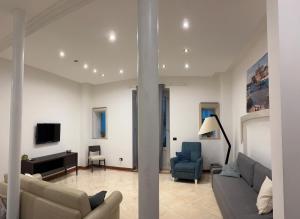 a living room with a couch and a tv at Graziano's House Case Vacanze in Bari