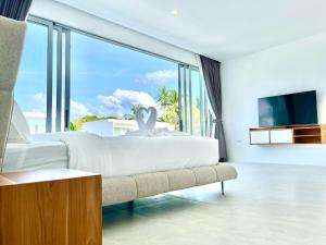 a bedroom with a white bed and a large window at Jungle View 3 bedroom Pool Villa in Meanam in Koh Samui 