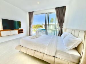 a bedroom with a large bed and a large window at Jungle View 3 bedroom Pool Villa in Meanam in Koh Samui  +50 photos