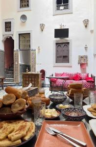 a table topped with lots of different types of bread at Riad Fez Panorama in Fès
