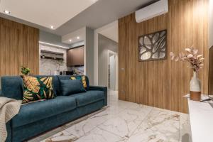 a living room with a blue couch and wooden walls at Ugo Bassi Apartments in Bologna