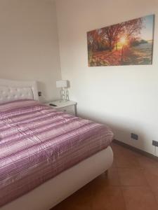 een slaapkamer met een bed en een schilderij aan de muur bij Ami Affittacamere 3 in Castel San Giovanni