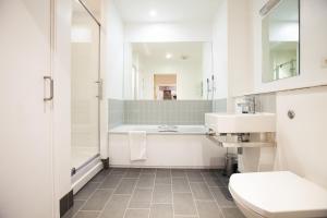 a bathroom with a tub and a toilet and a sink at Oxford Castle Apartments in Oxford +26 photos