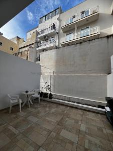 グジラにあるPrivate Room with Ensuiteの建物の前にテーブルと椅子