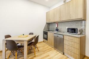 a kitchen with a table with chairs and a microwave at Two 2 Two Urban Stay in Vila Real +11 photos
