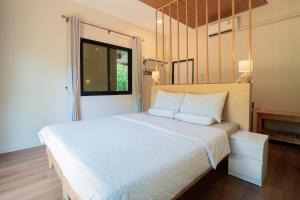 Ένα ή περισσότερα κρεβάτια σε δωμάτιο στο Just A Nap Khaoyai บ้านหลังใหญ่สำหรับครอบครัว