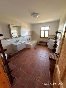 een badkamer met een bad en een wastafel en een ligbad bij Ferienhaus Anton in Eibenstock +13 foto's