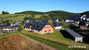 an aerial view of a large house on a hill at Ferienhaus Anton in Eibenstock +13 photos