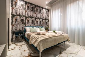 a bedroom with a bed with a wall of houses at Ugo Bassi Apartments in Bologna