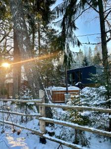 a cabin in the woods in the snow at Kakupesa Puhkemaja in Hara