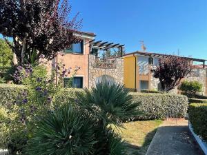 a house with a garden in front of it at Blu Marlin Apartment in Santa Maria Coghinas