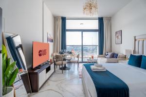 a living room with a large bed and a tv at GuestReady - Studio | City-View Getaway in Dubai