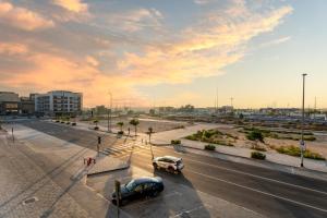 a street with two cars driving down a road at GuestReady - Studio | City-View Getaway in Dubai
