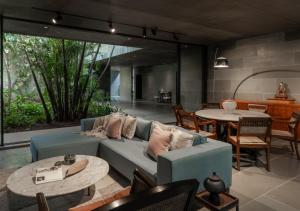 a living room with a blue couch and a table at LohonoStays Villa Gomti in Lonavala
