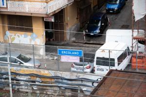 a view of a street with cars parked in front of a building at Happy Boutique Home Ercolano in Ercolano