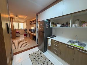a kitchen with a sink and a refrigerator at Estúdio dos sonhos in Rio de Janeiro