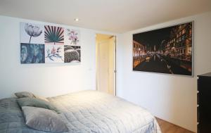 a bedroom with a bed and posters on the wall at Appartementen Purmerend B in Purmerend