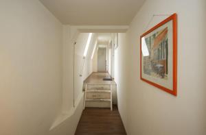 a hallway with a painting on the wall and a stairway at Appartementen Purmerend B in Purmerend