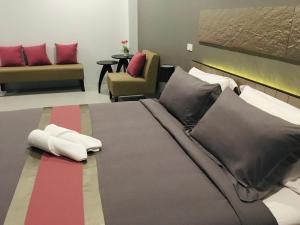 a bedroom with a large bed with two pillows at The Palm Residence in Hua Hin