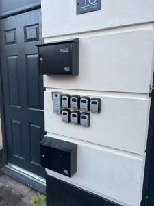 a house with a door with three pay phones on it at Modern Studio Central WV1 Appt 4 in Wolverhampton