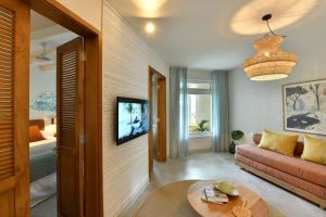 a living room with a couch and a table at Veranda Grand Baie Hotel & Spa in Grand Baie