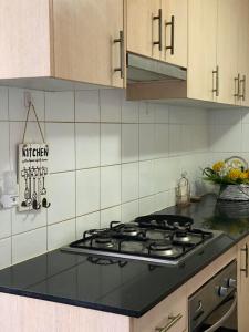 a kitchen with a stove top in a kitchen at Guildford room near Cafe and Train in Guildford