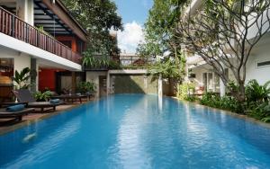 a swimming pool in the middle of a building at Indra Angkor Residence in Siem Reap