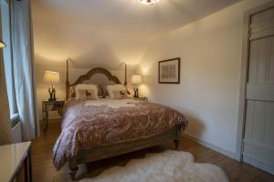 a bedroom with a bed and two lamps and a rug at Halyon Village in Greencastle +30 photos