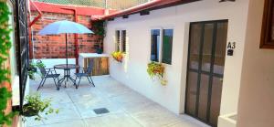 a small patio with a table and an umbrella at Casa Mariscal in Guatemala