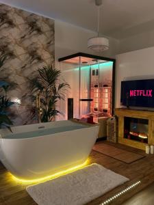 a bath tub in a living room with a tv at Ama Esclusive Spa Florence in Florence