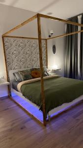 a bedroom with a bed with a wooden canopy at Ama Esclusive Spa Florence in Florence
